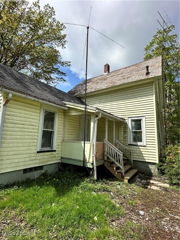 back of property featuring a chimney