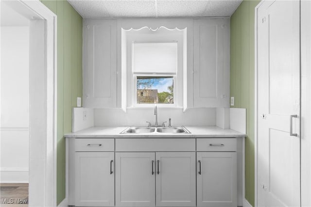 bar featuring a sink and a drop ceiling