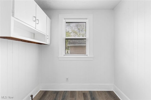 washroom with dark wood-style floors and baseboards