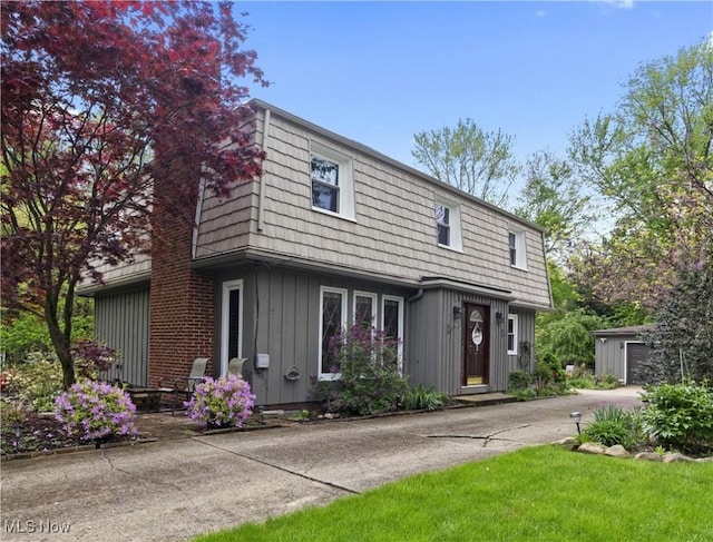 5550 Barton Rd, North Olmsted, OH 44070 - view of front of property featuring board and batten siding, an outdoor structure, and a garage