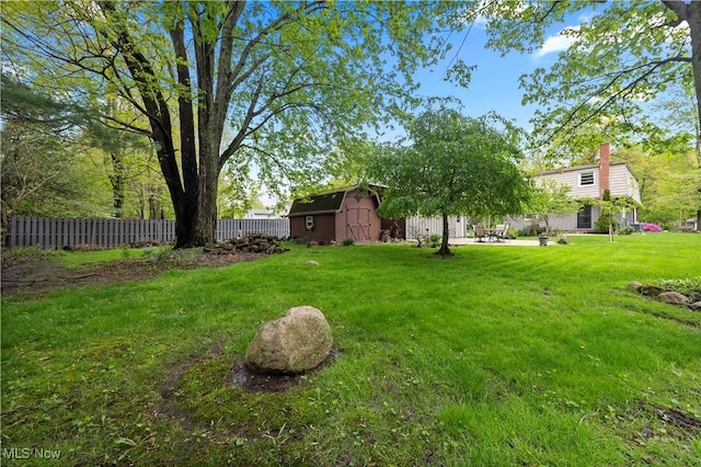 5550 Barton Rd, North Olmsted, OH 44070 - view of yard featuring an outdoor structure, a storage shed, and a patio area