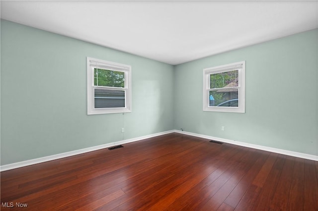 5550 Barton Rd, North Olmsted, OH 44070 - spare room with plenty of natural light, dark wood-style flooring, and baseboards