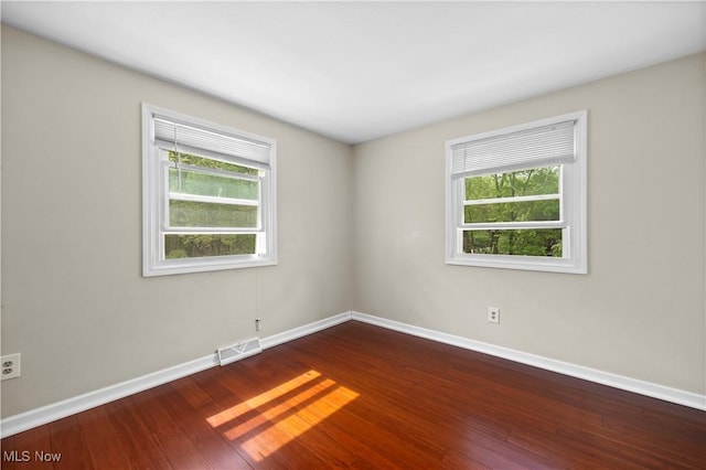 5550 Barton Rd, North Olmsted, OH 44070 - spare room with baseboards, plenty of natural light, and dark wood-style floors