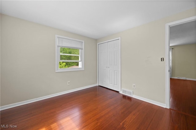 5550 Barton Rd, North Olmsted, OH 44070 - unfurnished bedroom featuring wood-type flooring, a closet, and baseboards