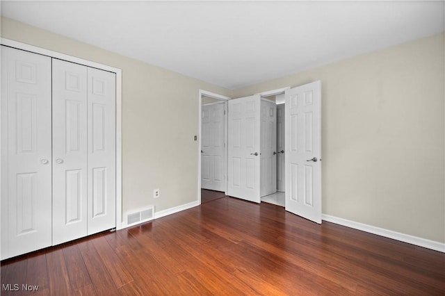 5550 Barton Rd, North Olmsted, OH 44070 - unfurnished bedroom with baseboards, wood finished floors, and a closet