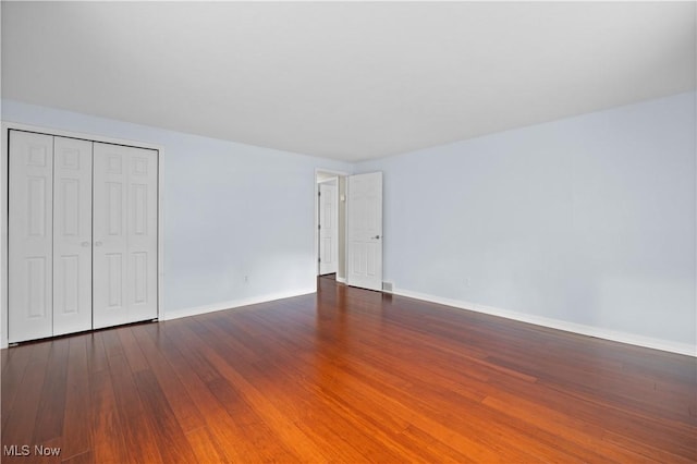 5550 Barton Rd, North Olmsted, OH 44070 - unfurnished bedroom with wood finished floors, baseboards, and a closet