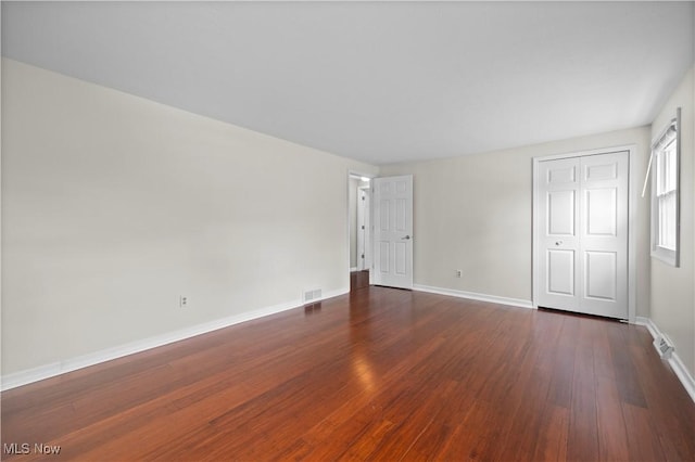 5550 Barton Rd, North Olmsted, OH 44070 - unfurnished bedroom with dark wood finished floors, baseboards, and a closet
