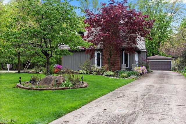 5550 Barton Rd, North Olmsted, OH 44070 - view of property hidden behind natural elements with an outbuilding, a front yard, and a detached garage
