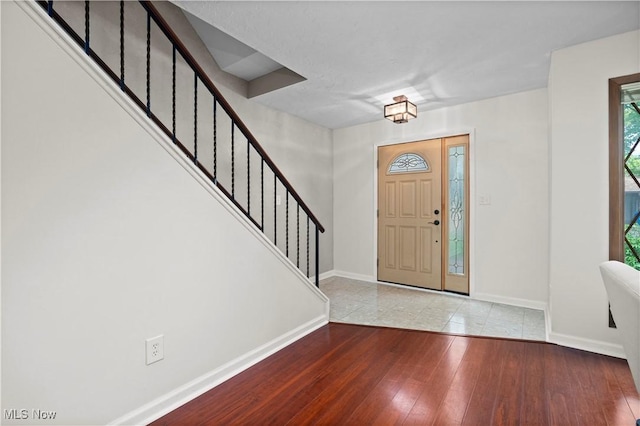 5550 Barton Rd, North Olmsted, OH 44070 - foyer entrance with baseboards, stairs, and wood-type flooring