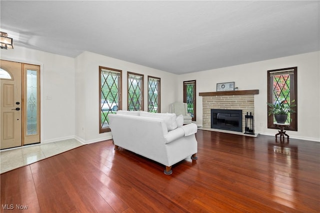 5550 Barton Rd, North Olmsted, OH 44070 - living room featuring hardwood / wood-style floors, plenty of natural light, baseboards, and a fireplace