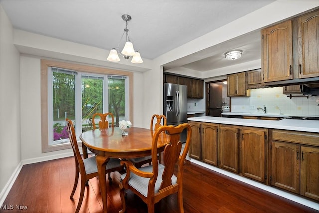 5550 Barton Rd, North Olmsted, OH 44070 - dining room with baseboards, a chandelier, and dark wood finished floors