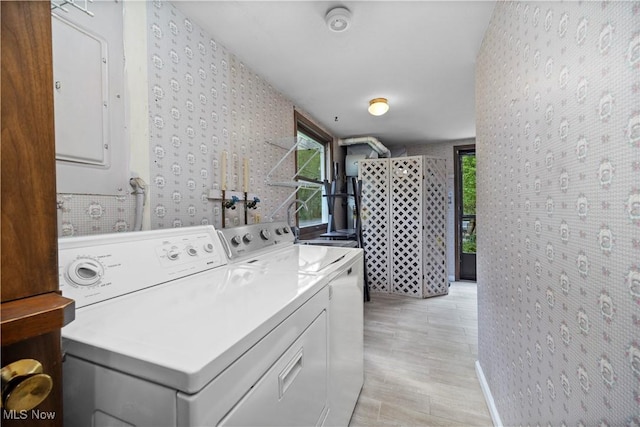 5550 Barton Rd, North Olmsted, OH 44070 - laundry area with electric panel, wallpapered walls, washer and clothes dryer, and light wood-style flooring