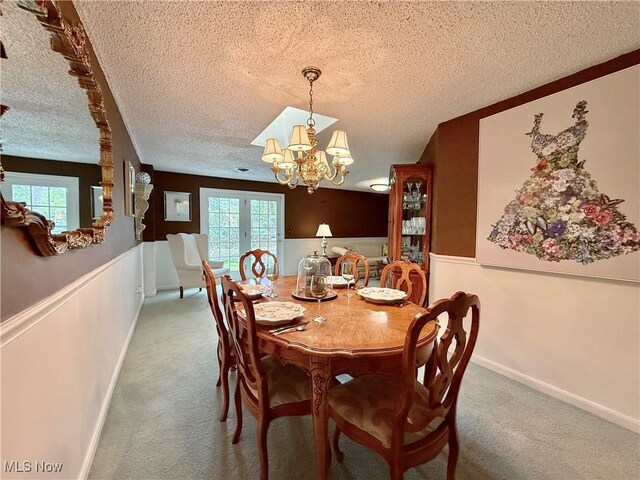 45 Meadowcrest Dr, Parkersburg, WV 26104 - carpeted dining area featuring a chandelier, a textured ceiling, and baseboards