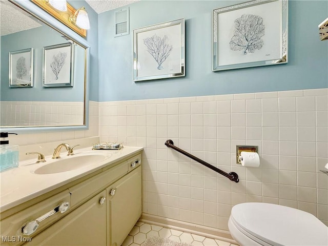45 Meadowcrest Dr, Parkersburg, WV 26104 - bathroom with toilet, tile walls, a textured ceiling, tile patterned floors, and vanity