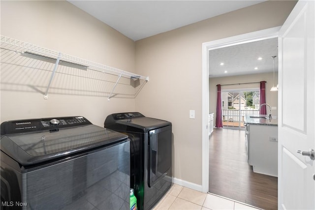 2273 Cranberry Creek Rd, Ravenna, OH 44266 - clothes washing area with washer and clothes dryer, light tile patterned flooring, baseboards, and recessed lighting