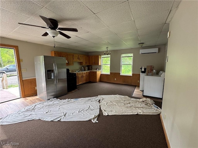 10270 State Route 550, Vincent, OH 45784 - kitchen featuring stainless steel fridge, washer and clothes dryer, a drop ceiling, a wainscoted wall, and a wall unit AC
