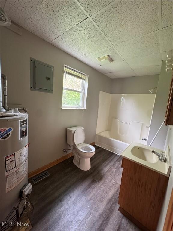 10270 State Route 550, Vincent, OH 45784 - full bath featuring water heater, electric panel, a paneled ceiling, toilet, and wood finished floors