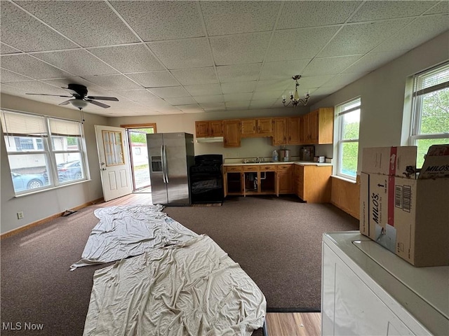 10270 State Route 550, Vincent, OH 45784 - kitchen with stainless steel fridge, gas stove, light countertops, a drop ceiling, and a chandelier