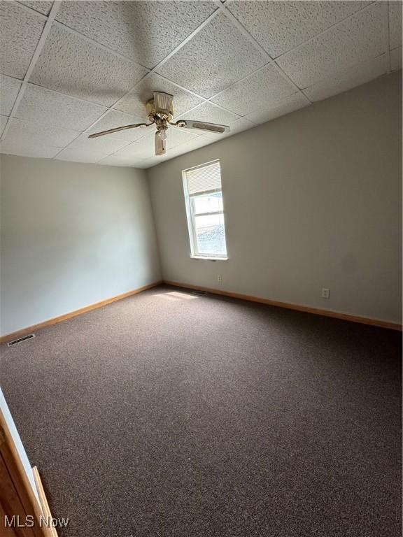 10270 State Route 550, Vincent, OH 45784 - empty room featuring a ceiling fan, a drop ceiling, carpet floors, and baseboards
