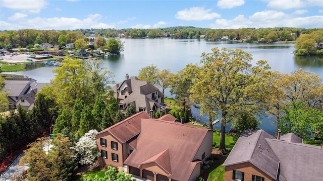 aerial view of residential area featuring a large body of water