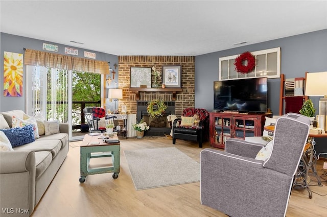 living room featuring wood finished floors and a fireplace