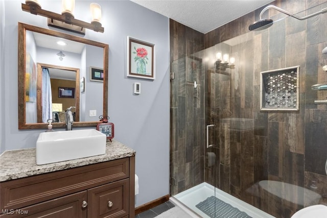 full bath with a stall shower, vanity, and tile patterned floors