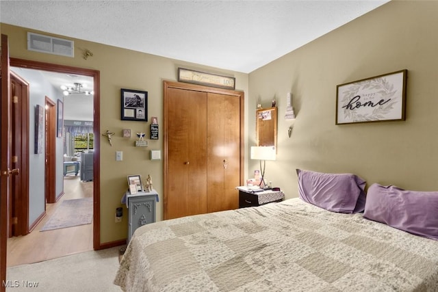 bedroom with light carpet and a closet