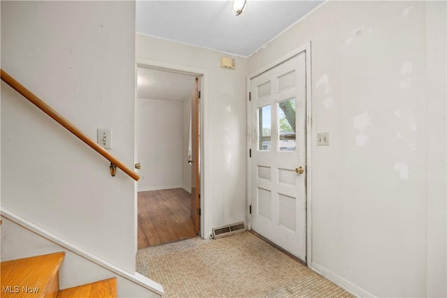 entrance foyer featuring stairs and baseboards