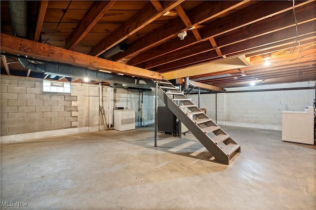 below grade area featuring stairs and washer and clothes dryer