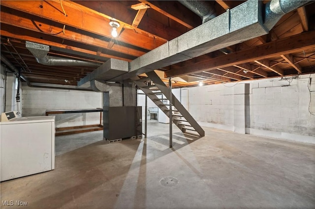 unfinished basement featuring washer / clothes dryer, stairs, and heating unit