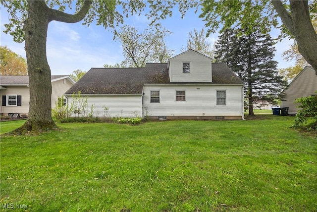 rear view of house with a yard
