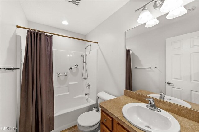 bathroom featuring toilet, shower / bathtub combination with curtain, and vanity