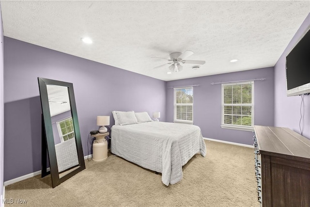 bedroom featuring light carpet, a textured ceiling, baseboards, a ceiling fan, and recessed lighting
