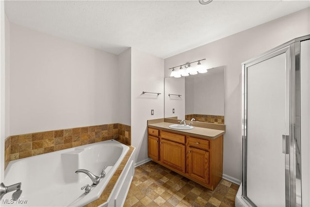 bathroom featuring a bath, vanity, and stone finish floors