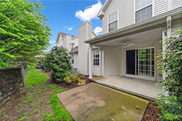 back of property featuring a patio area, ceiling fan, central AC unit, and a chimney