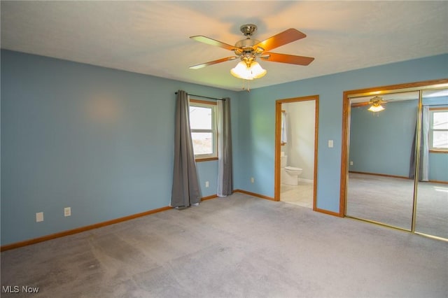 53350 High Ridge Rd, Bridgeport, OH 43912 - unfurnished bedroom featuring multiple windows, carpet flooring, baseboards, and ensuite bath
