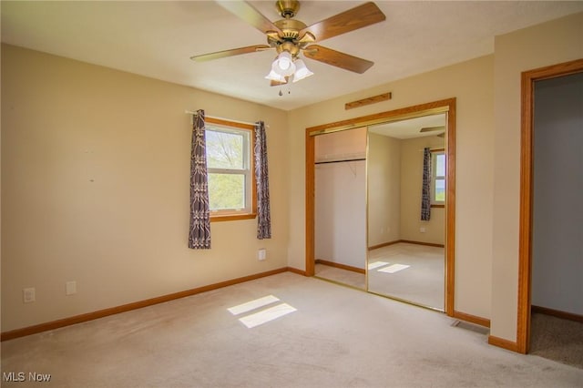 53350 High Ridge Rd, Bridgeport, OH 43912 - unfurnished bedroom with light colored carpet, baseboards, a closet, and ceiling fan