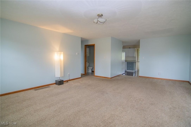53350 High Ridge Rd, Bridgeport, OH 43912 - unfurnished living room featuring baseboards and light carpet