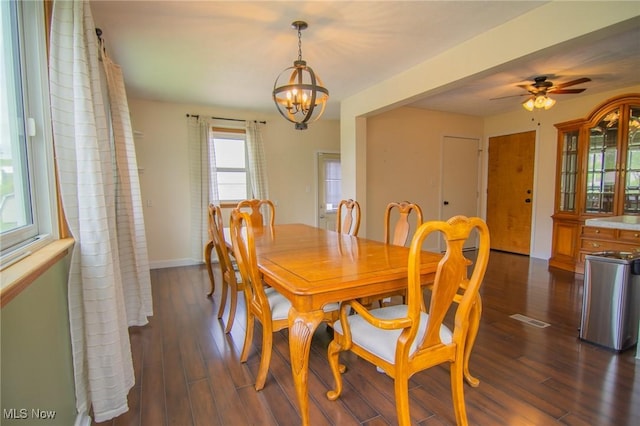 53350 High Ridge Rd, Bridgeport, OH 43912 - dining room featuring dark wood finished floors, a chandelier, baseboards, and a ceiling fan