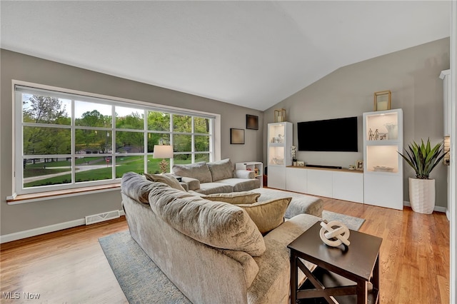 7805 Skylineview Dr, Mentor, OH 44060 - living area with vaulted ceiling, light wood-type flooring, and baseboards