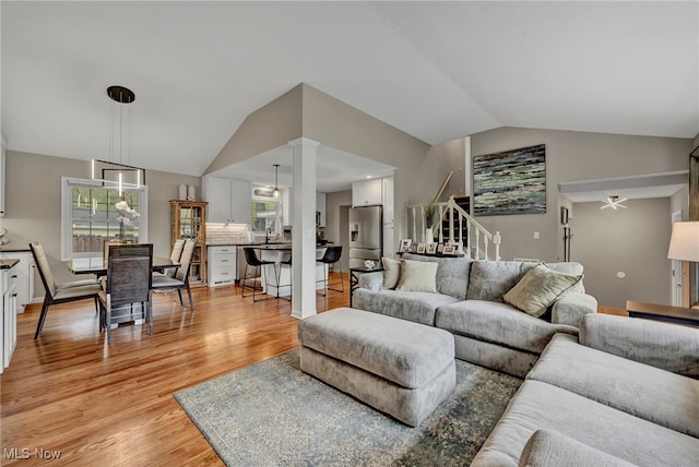 7805 Skylineview Dr, Mentor, OH 44060 - living room with lofted ceiling, light wood-style flooring, and stairs