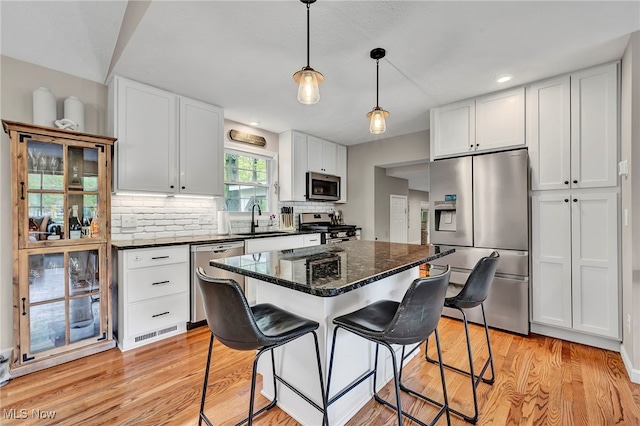 7805 Skylineview Dr, Mentor, OH 44060 - kitchen featuring appliances with stainless steel finishes, a sink, white cabinets, light wood finished floors, and recessed lighting