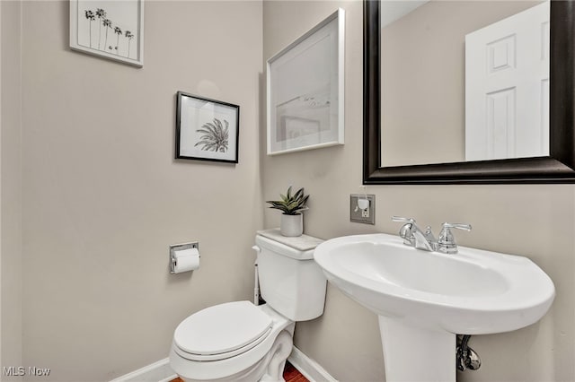 7805 Skylineview Dr, Mentor, OH 44060 - bathroom with toilet, a sink, and baseboards