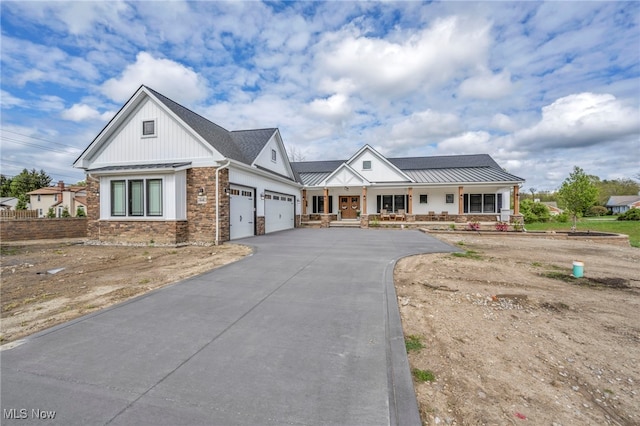 7440 Thatchum Ln, Concord, OH 44077 - modern inspired farmhouse featuring covered porch, a garage, asphalt driveway, and a standing seam roof