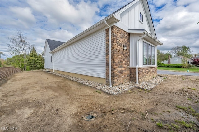 7440 Thatchum Ln, Concord, OH 44077 - view of side of property with stone siding and board and batten siding