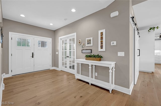 7440 Thatchum Ln, Concord, OH 44077 - foyer entrance with a barn door, light wood-style flooring, baseboards, french doors, and recessed lighting