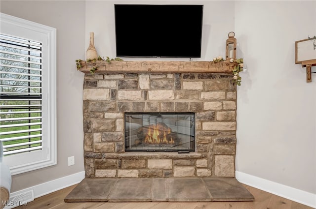 7440 Thatchum Ln, Concord, OH 44077 - detailed view of a fireplace, baseboards, and wood finished floors