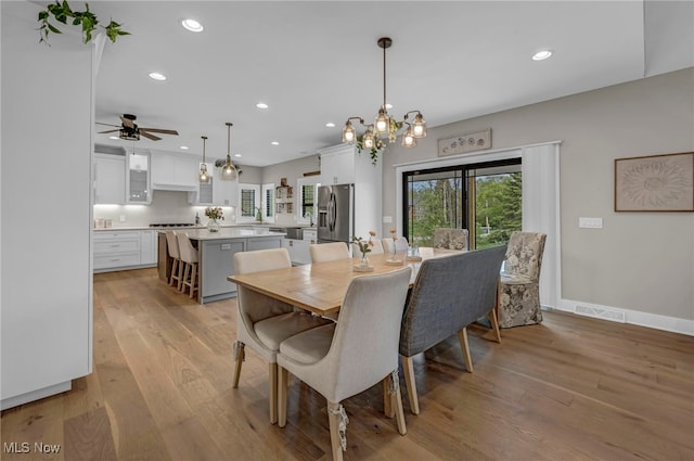 7440 Thatchum Ln, Concord, OH 44077 - dining room featuring light wood-style flooring, recessed lighting, a chandelier, a ceiling fan, and baseboards
