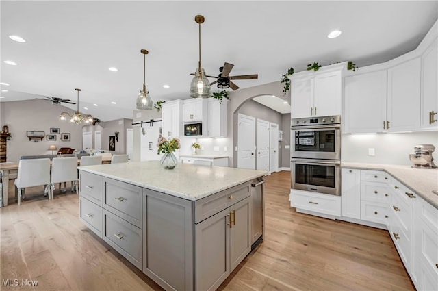 7440 Thatchum Ln, Concord, OH 44077 - kitchen featuring gray cabinets, ceiling fan, stainless steel double oven, recessed lighting, and light wood-style flooring