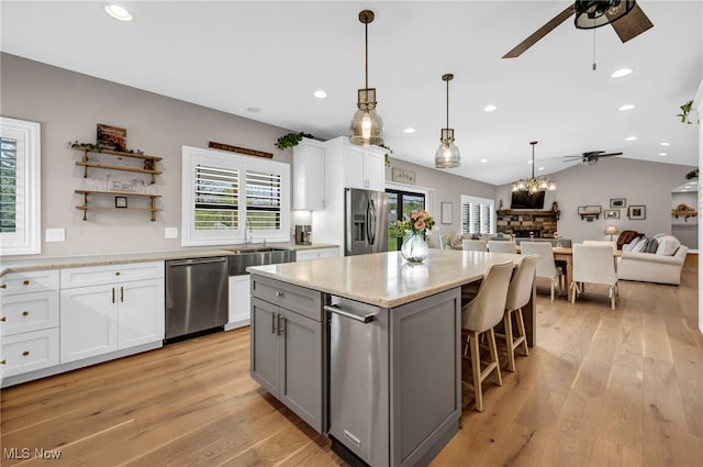 7440 Thatchum Ln, Concord, OH 44077 - kitchen featuring appliances with stainless steel finishes, a ceiling fan, plenty of natural light, open floor plan, and vaulted ceiling